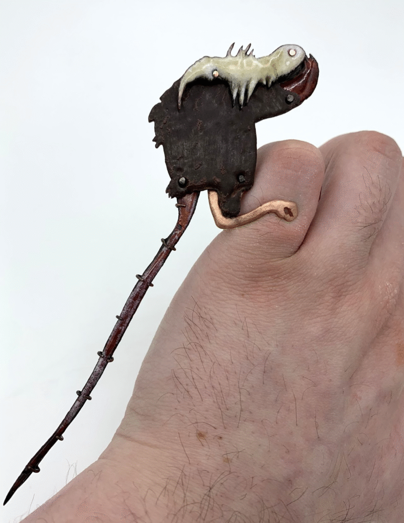 Roadkill , enamel on copper, 2 x 9 x .5 in.